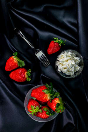 cup of ripe strawberries on wooden backgroundの写真素材