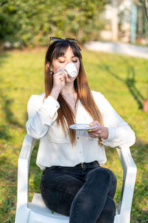 girls drinking coffee in the garden in the afternoonの写真素材