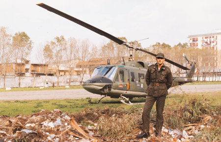 salerno, italy february 10 1970: soldiers with a helicopter behind them in the 70sのeditorial素材