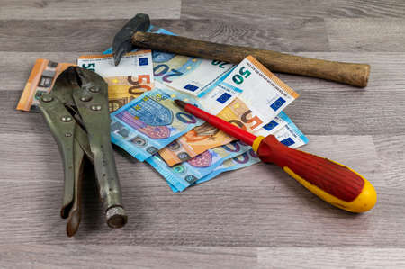 20 and 50 euro banknotes and wallet and cigar on wood backgroundの写真素材