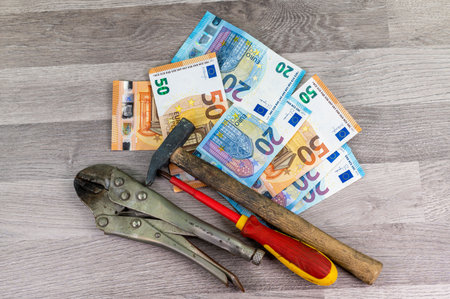 20 and 50 euro banknotes and wallet and cigar on wood backgroundの写真素材