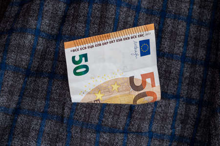 pocket of the plaid jacket coming out of 20 euro billsの写真素材