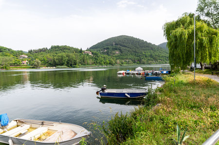 piediluco,italy june 23 2021:piediluco lake with boats by the lakeのeditorial素材