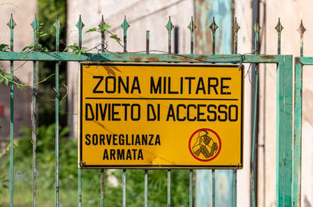 military sign that says military zone no access to armed surveillanceの写真素材
