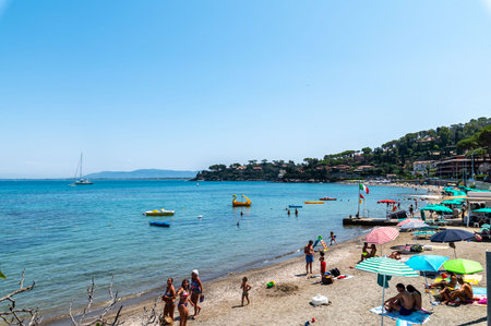 porto santo stefano, italy july 24 2021: small boats on the sea with bathersのeditorial素材