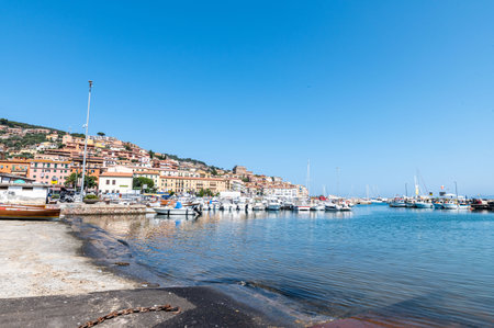 porto santo stefano, italy july 24 2021: small boats on the sea with bathersのeditorial素材