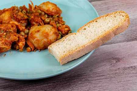composition of plate with cuttlefish and peas on wooden table with glass cutleryの写真素材