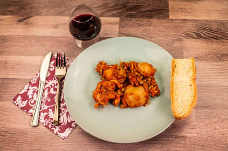 composition of plate with cuttlefish and peas on wooden table with glass cutleryの写真素材
