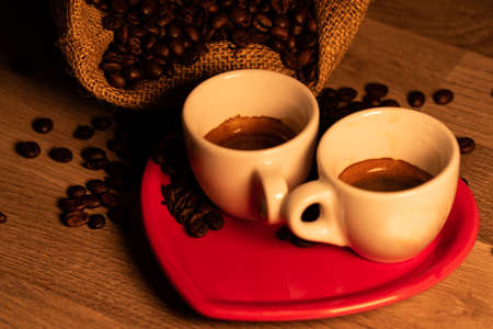 composition of coffee with grains and cups on wooden surfaceの写真素材