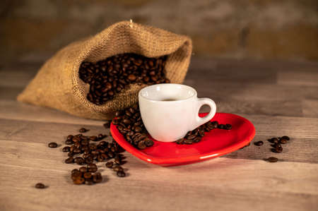 composition of coffee with grains and cups on wooden surfaceの写真素材