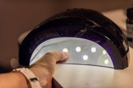 nail decorations with special uv gel using various color gel led lampの写真素材