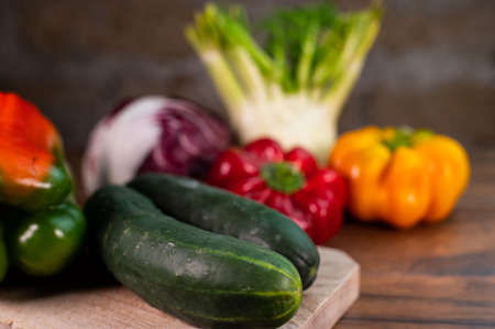 composition of vegetables with cutting board on wooden surfaceの写真素材