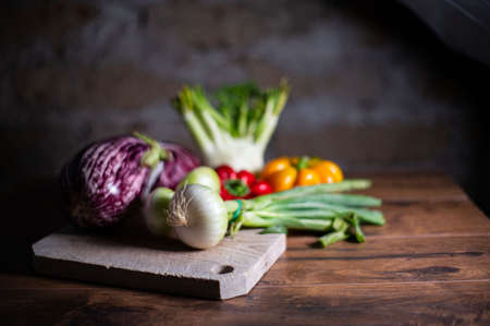 composition of vegetables with cutting board on wooden surfaceの写真素材