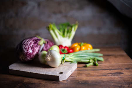 composition of vegetables with cutting board on wooden surfaceの写真素材