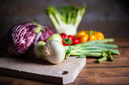 composition of vegetables with cutting board on wooden surfaceの写真素材