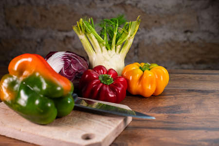 composition of vegetables with cutting board on wooden surfaceの写真素材