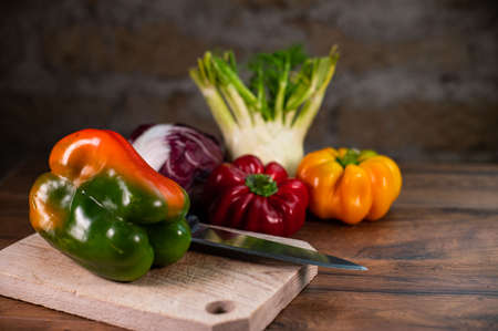 composition of vegetables with cutting board on wooden surfaceの写真素材