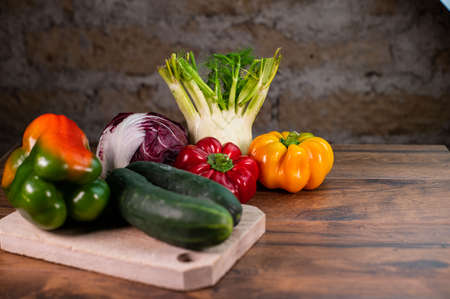 composition of vegetables with cutting board on wooden surfaceの写真素材