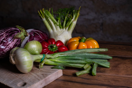 composition of vegetables with cutting board on wooden surfaceの写真素材