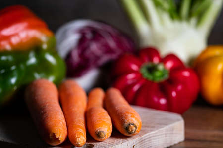 composition of vegetables with cutting board on wooden surfaceの写真素材