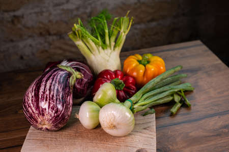 composition of vegetables with cutting board on wooden surfaceの写真素材