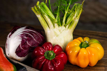 composition of vegetables with cutting board on wooden surfaceの写真素材