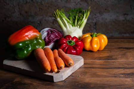 composition of vegetables with cutting board on wooden surfaceの写真素材