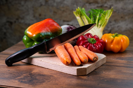 composition of vegetables with cutting board on wooden surfaceの写真素材