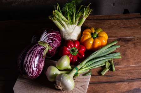 composition of vegetables with cutting board on wooden surfaceの写真素材