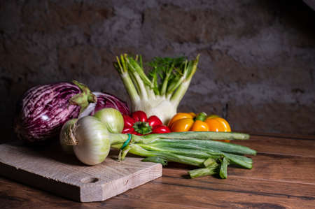 composition of vegetables with cutting board on wooden surfaceの写真素材