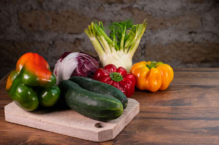 composition of vegetables with cutting board on wooden surfaceの写真素材