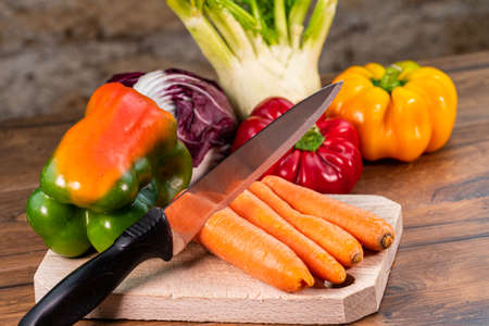composition of vegetables with cutting board on wooden surfaceの写真素材