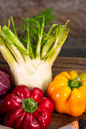 composition of vegetables with cutting board on wooden surfaceの写真素材