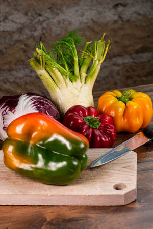 composition of vegetables with cutting board on wooden surfaceの写真素材