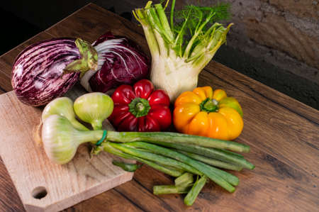 composition of vegetables with cutting board on wooden surfaceの写真素材