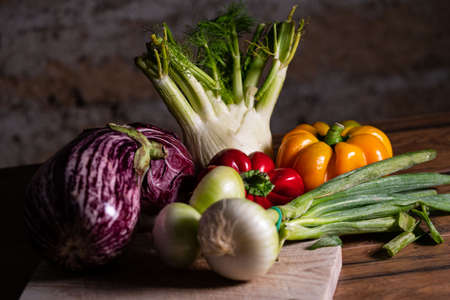 composition of vegetables with cutting board on wooden surfaceの写真素材