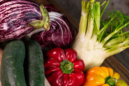 composition of vegetables with cutting board on wooden surfaceの写真素材