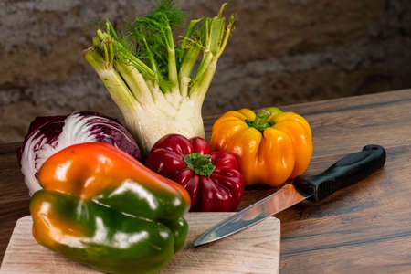 composition of vegetables with cutting board on wooden surfaceの写真素材
