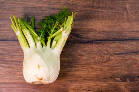 composition of vegetables with bark and cutting board on a wooden surfaceの写真素材