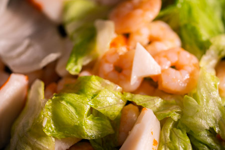 seafood salad composition with shrimps and surimi with cutlery and glass of white wine and lemonsの写真素材