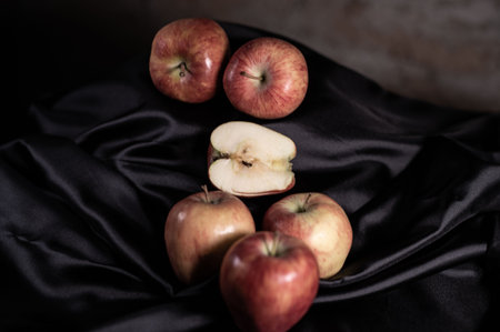 apples in golden basket on wooden countertopの写真素材