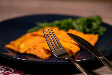 blue plate with fish ravioli with parsleyの写真素材
