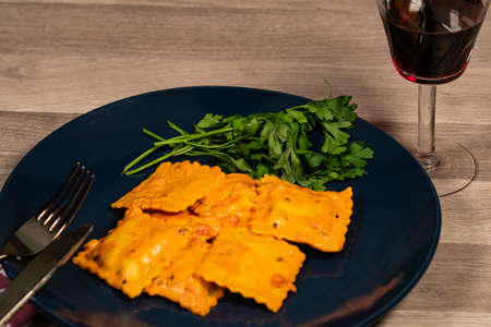 blue plate with fish ravioli with parsleyの写真素材