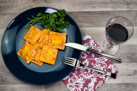 blue plate with fish ravioli with parsleyの写真素材