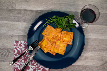 blue plate with fish ravioli with parsleyの写真素材