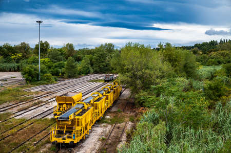landscape with yellow freight train stationaryの写真素材