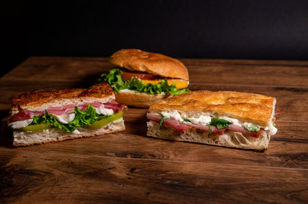 stuffed focaccia with cold cuts and vegetables on a wooden surfaceの写真素材