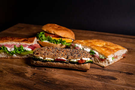 stuffed focaccia with cold cuts and vegetables on a wooden surfaceの写真素材