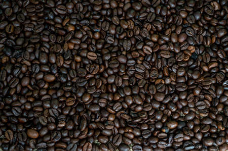 texture of roasted coffee beans on wooden surfaceの写真素材