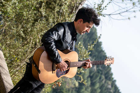close up of boy with guitar in natureの写真素材